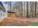 Backyard featuring a covered patio area nestled among mature trees providing privacy and shade at 629 Granite Ln, Loganville, GA 30052