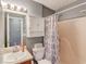 Bathroom with a white vanity and a shower tub combination behind a patterned shower curtain at 629 Granite Ln, Loganville, GA 30052