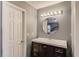 Bathroom with modern vanity, round mirror, and lighting fixture at 629 Granite Ln, Loganville, GA 30052