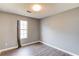 Vacant bedroom with wood-look flooring, and a window with neutral colored curtain at 629 Granite Ln, Loganville, GA 30052