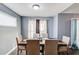 Dining area with a dark wood table, six chairs, and grey walls at 629 Granite Ln, Loganville, GA 30052