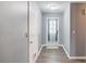 Entryway featuring hard wood floors and view of a white front door with paneled glass at 629 Granite Ln, Loganville, GA 30052