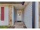 Close-up of the front entry with stone accents and light grey siding surrounding the glass-pane front door at 629 Granite Ln, Loganville, GA 30052