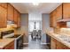 Galley kitchen features wood cabinets, wood countertops, black appliances, and opens to the dining area at 629 Granite Ln, Loganville, GA 30052