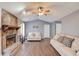 Living room featuring a stone fireplace, hardwood floors and neutral-colored couches at 629 Granite Ln, Loganville, GA 30052