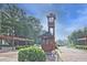 Inviting community entrance with a wooden clock tower and manicured landscaping at 783 Lost Creek Cir, Stone Mountain, GA 30088