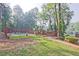 Community pool area with a lake view, surrounded by a fence and grassy area at 783 Lost Creek Cir, Stone Mountain, GA 30088