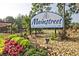 The 'Mainstreet' community sign surrounded by colorful flowers and lush landscaping at 783 Lost Creek Cir, Stone Mountain, GA 30088