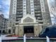 An eye-level exterior shot of the Park Towers entrance showing the fountain at 795 Hammond Dr # 1904, Atlanta, GA 30328