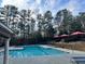 Community pool area with lounge chairs and picnic tables, perfect for relaxation at 795 Hammond Dr # 1904, Atlanta, GA 30328