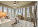 Bright main bedroom with large windows, neutral decor, and an exposed concrete ceiling at 890 Memorial Se Dr # 102, Atlanta, GA 30316