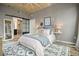 Cozy main bedroom with barn door, exposed concrete ceilings, and neutral colors at 890 Memorial Se Dr # 102, Atlanta, GA 30316