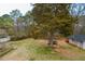 Expansive backyard with mature tree offers plenty of space for outdoor activities and features a detached garage at 2511 Hope Dr, Conyers, GA 30094