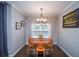 Dining room featuring wood table and chairs, chandelier, and natural light at 2511 Hope Dr, Conyers, GA 30094