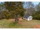 View of large backyard with a detached two-car garage, perfect for extra storage and hobbies at 2511 Hope Dr, Conyers, GA 30094