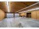 Large garage interior featuring two garage doors, shelving, and a concrete floor, perfect for a workshop at 5965 South Sw Ave, Austell, GA 30168