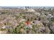 A high angle view showing the house surrounded by trees in a neighborhood and a distant cityscape at 1005 W Kingston Dr, Atlanta, GA 30342