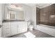 Modern bathroom with granite countertops, tile floor, and bathtub with shower at 1005 W Kingston Dr, Atlanta, GA 30342