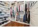 Organized walk-in closet featuring ample storage and hardwood floors at 1005 W Kingston Dr, Atlanta, GA 30342