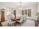 Dining room featuring a dark wood table and seating for eight with views through a large window at 1005 W Kingston Dr, Atlanta, GA 30342