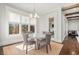 Bright dining room with a round glass table, neutral chairs, and large windows at 1005 W Kingston Dr, Atlanta, GA 30342