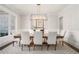 Formal dining room with a modern chandelier, large table with seating for eight, and large window at 1005 W Kingston Dr, Atlanta, GA 30342