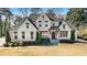 Charming brick house with well-kept lawn, complemented by neat shrubbery and symmetrical landscaping at 1005 W Kingston Dr, Atlanta, GA 30342