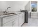 Bright laundry room with granite countertop sink and modern washer at 1005 W Kingston Dr, Atlanta, GA 30342