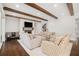 Living room showcasing exposed wood beams, hardwood flooring, and neutral colored furniture at 1005 W Kingston Dr, Atlanta, GA 30342