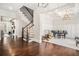 Open-concept area with staircase, hardwood floors, fireplace, and a grand piano in the living space at 1005 W Kingston Dr, Atlanta, GA 30342