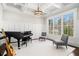 Bright living room showcasing a grand piano, large windows, and elegant wainscoting at 1005 W Kingston Dr, Atlanta, GA 30342