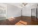 Spacious bedroom with hardwood floors, ceiling fan, and ensuite bathroom at 1005 W Kingston Dr, Atlanta, GA 30342