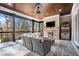 Inviting screened porch with fireplace, ceiling fan, and outdoor seating, perfect for relaxing and enjoying the view at 1005 W Kingston Dr, Atlanta, GA 30342