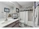 Charming bathroom with patterned tile, unique light fixture, shower-tub combo, and vanity at 1914 Lakeshore Overlook Nw Cir, Kennesaw, GA 30152