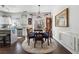 Bright dining area featuring modern chandelier and wood floors, open to the kitchen at 1914 Lakeshore Overlook Nw Cir, Kennesaw, GA 30152