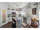 Modern kitchen features white cabinets, stainless steel appliances, and a central island with seating at 1914 Lakeshore Overlook Nw Cir, Kennesaw, GA 30152