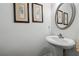 Stylish powder room with a pedestal sink and decorative wall art at 1914 Lakeshore Overlook Nw Cir, Kennesaw, GA 30152