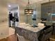 Open concept dining area flowing into the kitchen, enhanced by a stylish light fixture at 330 Warm Springs Cir, Roswell, GA 30075