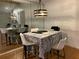 Inviting dining area featuring modern lighting and mirrored wall, perfect for entertaining guests at 330 Warm Springs Cir, Roswell, GA 30075