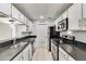 Kitchen features stainless steel appliances, white cabinets and tiled floor at 330 Warm Springs Cir, Roswell, GA 30075