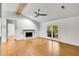 Bright living room with wood-look floors, white brick fireplace and sliding door to balcony at 330 Warm Springs Cir, Roswell, GA 30075