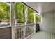 Enjoy the outdoors on this porch with its wooden railing and scenic green view of trees and landscape at 330 Warm Springs Cir, Roswell, GA 30075