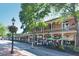 Charming two-story commercial brick building featuring balconies and inviting patio seating along the sidewalk at 330 Warm Springs Cir, Roswell, GA 30075