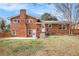 Backyard view of a brick home with a patio and a grass yard at 1485 Camelot Ln, Tucker, GA 30084