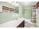 Bathroom featuring a tile shower and tub, classic sink, and a large mirror at 1485 Camelot Ln, Tucker, GA 30084