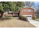 Charming brick home featuring a two-car garage and a well-maintained front yard at 1485 Camelot Ln, Tucker, GA 30084