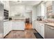 Functional kitchen with neutral countertops, white cabinets, and stainless steel sink at 1485 Camelot Ln, Tucker, GA 30084