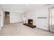 Cozy living room featuring a brick fireplace, plush carpet, and natural light at 1485 Camelot Ln, Tucker, GA 30084