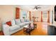 Inviting living room featuring hardwood floors, a ceiling fan, and a comfortable gray sofa at 1485 Camelot Ln, Tucker, GA 30084