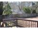 View of the backyard of the home with a wood fence and mature landscaping at 2031 Lakewood Cir, Grayson, GA 30017